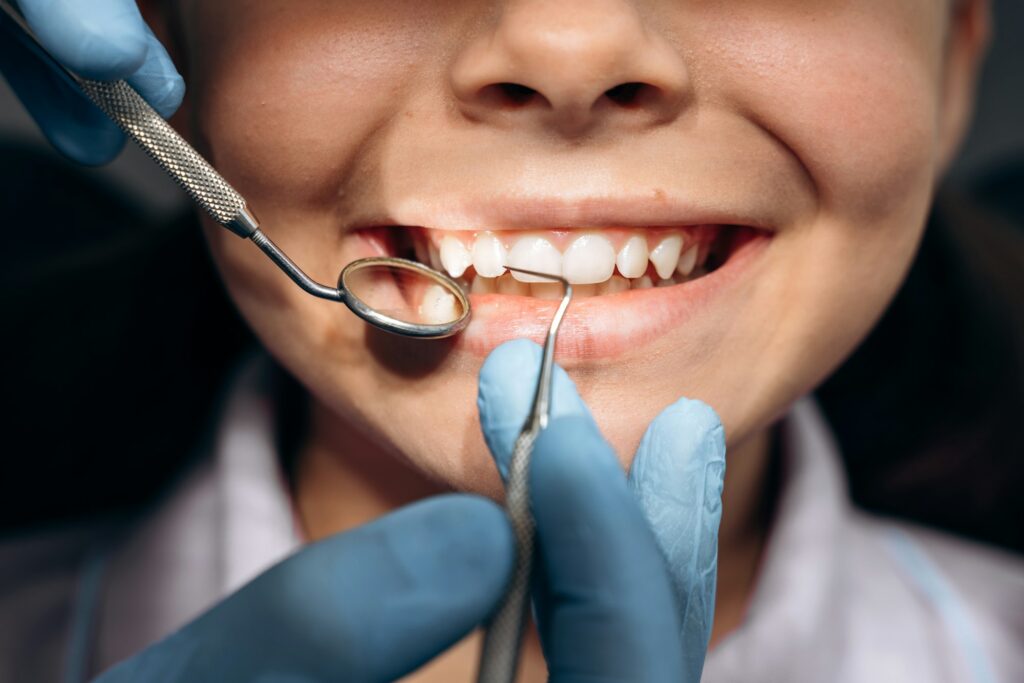 The dentist checks the teeth of a young patient.